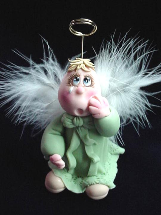 Porcelain Crying Angel Figurine-Handmade with porcelain. Every detail is hand molded piece by piece. Feathers and gold wire is used for final details. This unique piece is set up in a wooden base as final touch. One-of-a-kind design. Handmade Crafts.