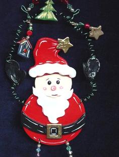 This porcelain handmade ornament is painted in pearly white, red and black bright colors. Gold enamel and foil effects are applied.  Each detail is set one by one. Green wire and glass beads are used for final details. Unique Design!