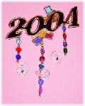 2004 Celebration Pin- This porcelain handmade pin / ornament is painted in glossy bright black and gold enamel details. Glitter, glass beads and wire are used for final details. Unique Design!