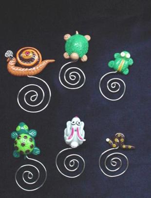 Handmade of glazed Fimo. Nickel wire is used for final details. You can use them as bookmarks or paper clips. Different, fun and functional! Unique designs for any taste! More designs will be available soon!