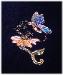Flower & Butterfly Pin- This porcelain handmade, hand cut and hand-painted beautiful pin  is painted in translucent bright colors and gold enamel details. Embellished w/AB, Amethyst, Lt. Amethyst and Topaz Austrian Crystals. Gold plated wire and glass beads are used for final details. Unique design, one-of-a-kind ! 100% handmade.