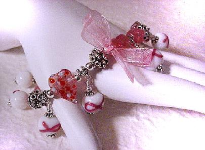 Cancer Awareness Bracelet-Because we want your customers to have this bracelet, the earrings or the bookmark, let's celebrate HOPE,COURAGE,STRENGTH and LOVE... The PRODUCTION TIME during the month of September for the Cancer Awareness items will be ONE WEEK or less!!! Bracelet is: Handcrafted with glass beads and bali sterling silver. Stretch cord for size flexibility. Pink organza ribbon. SS bali beads may vary in design, depending on availability. Just Exquisite! 