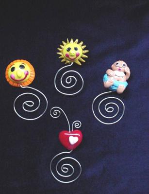 Handmade of glazed Fimo. Nickel wire is used for final details. You can use them as bookmarks or paper clips. Different, fun and functional! Unique designs for any taste! More designs will be available soon!