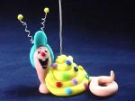 Confetti Snail Photo or Note Holder-  Handmade with glazed Fimo. Nickel and silver wire are used for final details. 