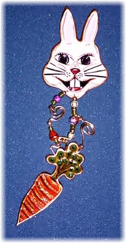 This porcelain handmade pin is hand-painted in translucent paints,  bright pastel colors and gold enamel details. Accented w/Medium and 5mm Amethyst and  Emerald Austrian Crystals. The carrot is embellished w/translucent Orange Glass Glitter. Gold plated wire and glass beads are used for final details. Unique Design!