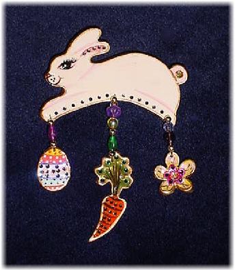 Easter Bunny Pin- This porcelain handmade pin is hand-painted in translucent paints,  bright pastel colors and gold enamel details. Accented w/Medium and 5mm Amethyst, Emerald, AB and Topaz  Austrian Crystals. Gold plated wire and glass beads are used for final details. Unique Design!