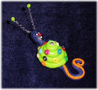 Handmade with glazed Fimo. Nickel and silver wire are used for final details. Pins are embellished with Austrian crystals.