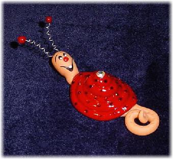  Handmade with glazed Fimo. Nickel and silver wire are used for final details. Pins are embellished with Austrian crystals.