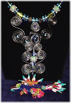 This beautiful set is made with beautiful watery colors glass beads. Necklace fish pendant is made of glazed Fimo.  Pewter findings are added for final details. Nickel wire is used for the clasps. Silver plated wire is used to embellish the glass beads and the Fimo creation.Very Unique and elegant!