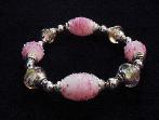 Handcrafted Jewelry Pink Glass Beads Bracelet -  Handcrafted with Pink and White  Large oval and medium round Glass beads. Transparent Lampwork pink  roses flower glass beads are used for a floral and romantic look. Embellished with Silver plated  beads and findings. Stretch cord is used for bracelet band.  Beautiful and Elegant! 