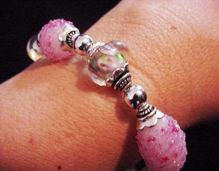 Handcrafted Jewelry Pink Glass Beads Bracelet -  Handcrafted with Pink and White  Large oval and medium round Glass beads. Transparent Lampwork pink  roses flower glass beads are used for a floral and romantic look. Embellished with Silver plated  beads and findings. Stretch cord is used for bracelet band.  Beautiful and Elegant! 