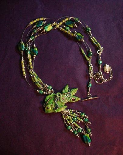 Dichroic Glass and Polymer Clay Green Fish Pendant Necklace - Handcrafted with Lime Green and Turquoise Blue Dichroic medium round and square large Glass beads. Czech Lime Green and Aquamarine Glass Seed Beads are used to embellish the necklace.  Silver plated  beads, fish charm, crimp tubes, final chain, clasp and findings are used for final details. Swarovski Crystals are used to accent the Polymer Clay Green Fish Pendant. Beadalon 19 flexible .018 in stringing wire is used to complete and embellish this unique creation. Beautiful and Elegant!
