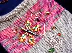 Hand-knitted with silk-wool. Decorated with a handmade Fimo butterfly, glass beads and copper wire. The butterfly is embellished with Austrian Crystals. Purse hanger is also handmade with copper and wooden beads. Unique design!  