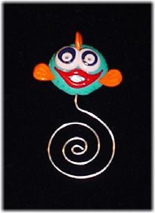 Lt. Blue Fishy Bookmark-Handmade of glazed Fimo. Nickel wire is used for final details. You can use them as bookmarks or paper clips. Different, fun and functional! Unique designs for any taste! More designs will be available soon!