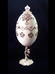 Madame Butterfly Eggypiece- Painted in matte light yellow and gold enamel details. Top opens. Inside, a porcelain butterfly accented w/glitter and Austrian Crystals, rest on porcelain roses in pastels colors. Accented w/AB, amethysts and gold Austrian Crystals. 18K gold plated stand and findings. Glorious music inside as a final element. Decorated box available for this eggypiece. 