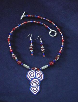 This beautiful set is made with patriotic colors (white, blue and red) glass beads. Necklace pendant is made of glazed Fimo. Pewter findings and clasps are added for final details. Very Patriotic and elegant!