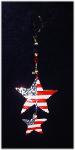 Patriotic 2 Stars Ornament- This porcelain handmade ornament is painted in glossy patriotic colors. Also some foil effects are applied. Austrian crystals, glass beads and wire are used for final and hanging details.