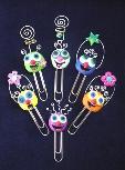 Handmade with glazed Fimo. Silver wire, glass beads, tiny bells and large paper clips. Functional, colorful, funny and durable. Make everyone laugh with these funny 'Pimpollos' Faces! Some are also note holders.