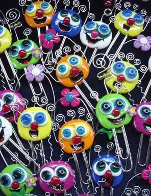 Handmade with glazed Fimo. Silver wire, glass beads, tiny bells and large paper clips. Functional, colorful, funny and durable. Make everyone laugh with these funny 'Pimpollos' Faces! Some are also note holders.