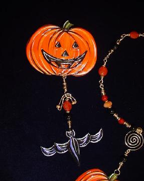 Halloween Pumpkin w/Bat Pin-This porcelain handmade pin is painted in glossy orange. Bat is painted in glossy black w/ gold Austrian Crystals for the eyes. Glass beads and wire are used for final details.Unique Design!