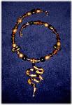 Clay Snake Necklace- This clay handmade necklace is hand-painted in antique gold, black and copper colors. Accented w/blown glass beads, metal and clay handmade beads. The snake is handmade with clay. Gold plated wire and findings are  used for final details. Unique Design and Very wild!