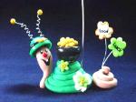 St. Patrick's Day Snail Photo or Note Holder, handmade crafts- Handmade with glazed Fimo. Nickel and silver wire are used for final details. Each Item can be personalized or the note can bring a special message. (Please, specify it with your order)