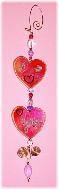I Love You Hearts Ornament-This porcelain handmade ornament is painted in bright colors and gold enamel details. AB Austrian Crystals are used for the 