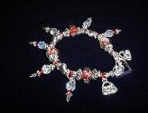 Handcrafted Jewelry Red & White Crystal & Glass Beads Bracelet - Handcrafted with Red and White Glass beads. Transparent Lampwork white and pink  roses flower glass beads are used for a floral and romantic look. Austrian Swarovski Crystals AB are used to embellish the bracelet. Silver plated  beads, charms and findings are used for final details. Stretch cord is used for flexibility  Beautiful and Elegant!