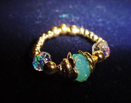 Handcrafted Faceted Swarovski Crystals Goldplated Birth Month Rings - Handcrafted Faceted Swarovski Crystals Goldplated Rings- Handcrafted with Faceted Austrian Swarovski Crystals, Gold Plated findings and beads. Stretch cord is used to give flexibility. Each ring will come with two AB crystals on each side. Please choose the crystal for the center  according to the month of your birth. Beautiful and Elegant to wear anytime.