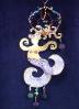 Whimsical Mermaid- This porcelain decor ornament is painted in antique gold,translucent and bright colors paints. Gold enamel is used for final details. Embellished w/real polished stones. Accented w/Amethyst Austrian Crystals and glass beads. Copper and gold color wire are used for decor and hanging details. Unique Design!