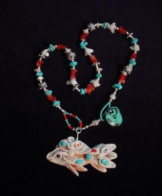 Handcrafted White Fish and Turquoise Necklace - Fish pendant handmade with polymer clay and embellished with Sleeping Beauty Turquoise Cabs. Fiber optic Orange and Mother of Pearls Beads are also used. Sterling Silver Bali Beads and findings. Turquoise medium doughnut is used as a clasp.Unique design! 