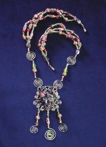 his unique set is made with Fimo (Cat Face), embellished with safari design wooden and glass beads. Gold plated wire, findings and clasps are used for final details. Accented Austrian crystals for the eyes. Very different! Great for the cat lovers!